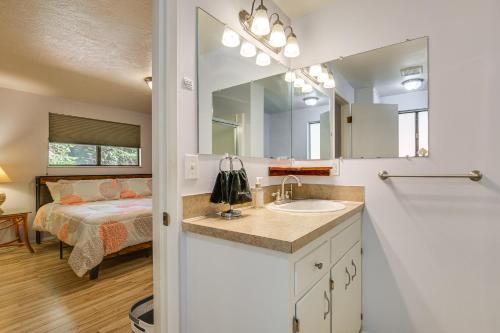 a bathroom with a sink and a bedroom with a bed at Creative Escape! Eagle's Nest Hideaway in Cottage Grove