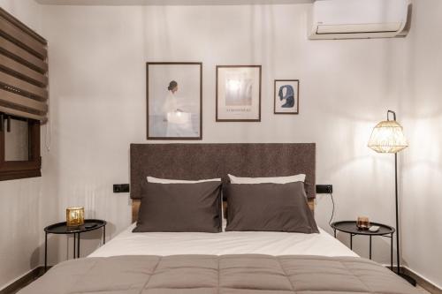 a bedroom with a large bed with two side tables at Casa Calma in Volos