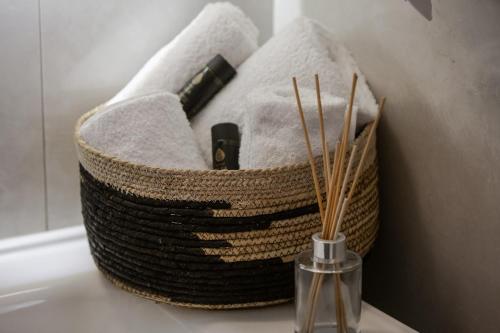 a basket filled with towels on top of a sink at Casa Calma in Volos
