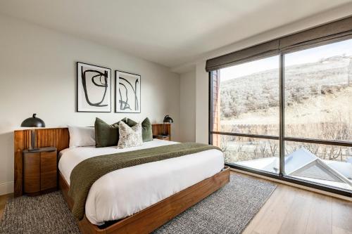 a bedroom with a large bed and a large window at Main & SKY Park City Utah in Park City