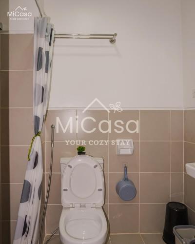a bathroom with a toilet and a sign on the wall at MiCasa South Residences Cozy & Affordable Stay in Manila