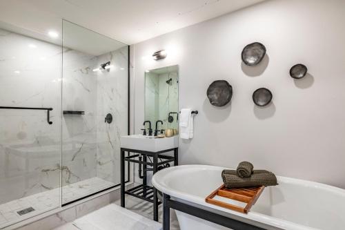a bathroom with a tub and a shower and a sink at Main & SKY Park City Utah in Park City