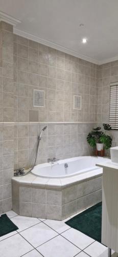 a large bathroom with a tub in a room at The Barn Haven in Kyalami