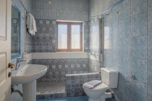 a bathroom with a toilet and a sink at Methoni Beach Hotel in Methoni