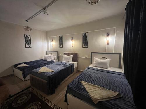 a room with two beds with blue and white at Backpackers Room 3 in Naj‘ al Maḩaţţah