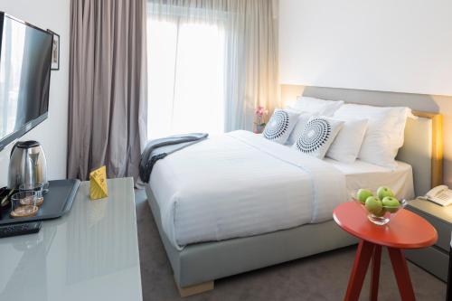 a hotel room with a bed and a television at Livris Hotel in Zagreb