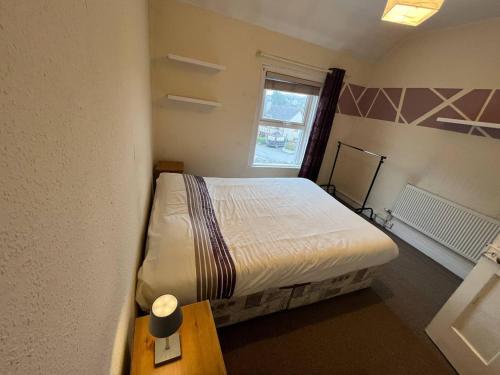 a small bedroom with a bed and a window at Bayview in Ballysadare