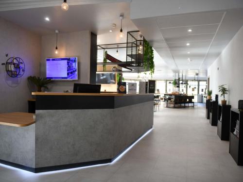 a lobby of a restaurant with a reception desk at ibis Chateauroux in Châteauroux