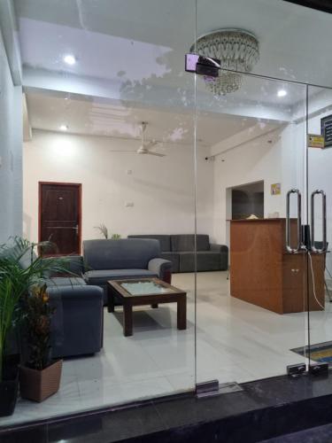 a living room with a couch and a table at Wings Hotel & Hostel in Trincomalee