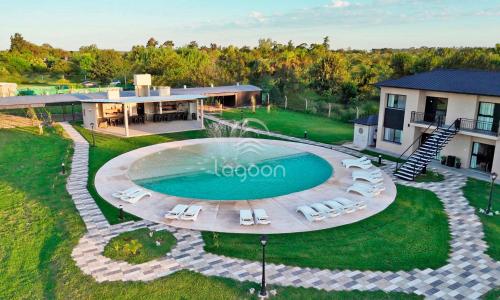 an overhead view of a pool with chairs and a house at Lagoon Miramar in Miramar