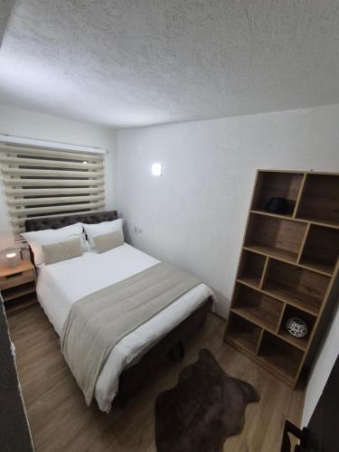 a bedroom with a bed and a book shelf at Royal in Sarajevo