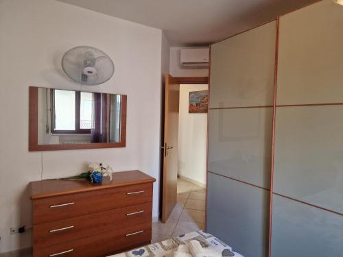 a bedroom with a dresser and a mirror and a closet at Cavalluccio Marino-Central-with Balcony by Gessica Holiday in Polignano a Mare