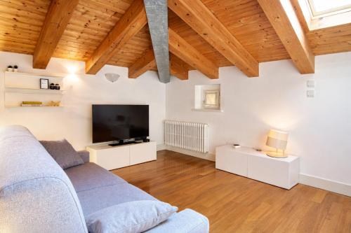 a living room with a couch and a tv at Apartments Trieste Centro I 2 in Trieste