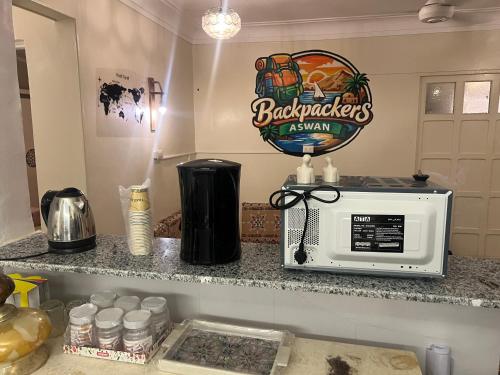 a kitchen counter with a microwave on top of it at Backpacker Room 2 in Aswan