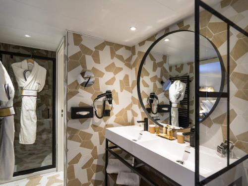 a bathroom with a sink and a mirror at Mercure Cannes Mandelieu in Cannes