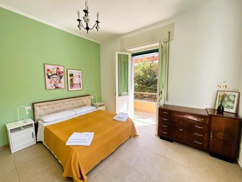 a bedroom with a bed and a dresser and a window at Casa Melina - Pesaro Mare in Pesaro