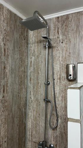 a shower with a shower head in a bathroom at MI HOGAR ES TUYO in Punta Arenas