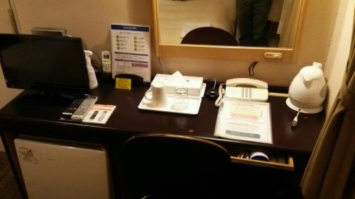a desk with a computer and a telephone on a plane at Hosplitality In Yawatajuku in Ichihara