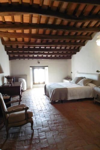 a bedroom with a large bed and a wooden ceiling at Can Mora de Dalt in Sant Vicenç de Montalt