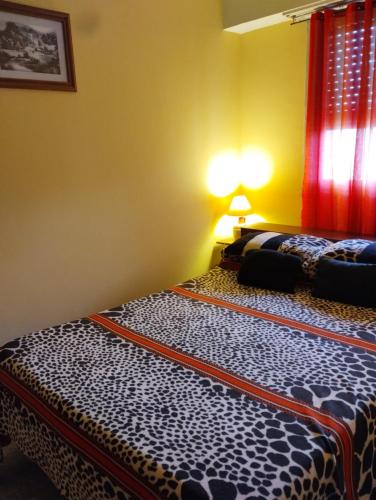 a bedroom with a bed in a room at La perla depto in Mar del Plata