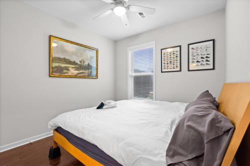 a bedroom with a bed and a ceiling fan at Entire DC House 2BR 2BA Fire Pit Free Parking Near Capitol Hill in Washington, D.C.