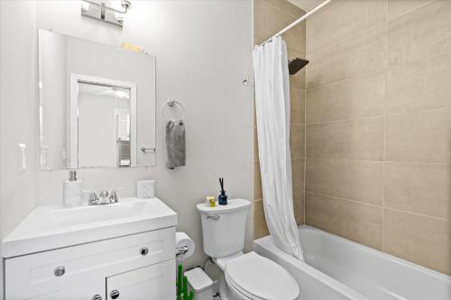a bathroom with a toilet and a sink and a shower at Entire DC House 2BR 2BA Fire Pit Free Parking Near Capitol Hill in Washington, D.C.
