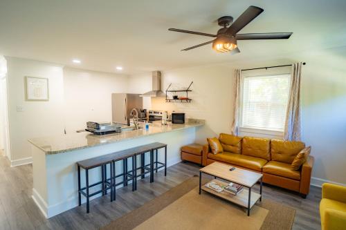 a living room with a couch and a kitchen at Renovated 2 Bed Walltown Home Walk to Duke! A in Durham