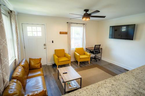 a living room with a couch and chairs and a table at Renovated 2 Bed Walltown Home Walk to Duke! A in Durham