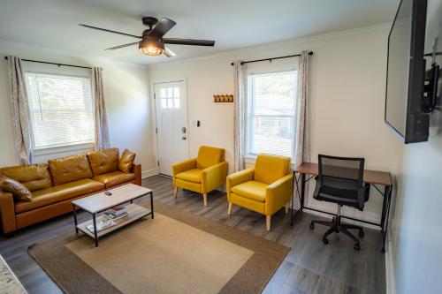 a living room with a couch and chairs and a table at Renovated 2 Bed Walltown Home Walk to Duke! A in Durham