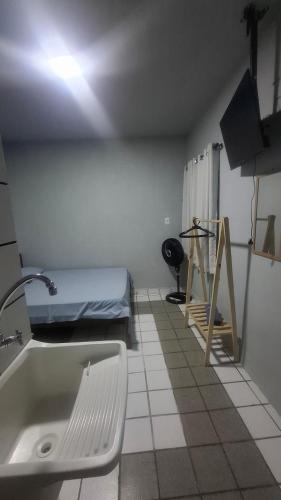 a bathroom with a sink and a bed in a room at Pousada São Paulo - Quartos com WC Exclusivo in Recife