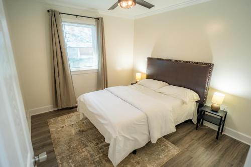 a bedroom with a large white bed and a window at Renovated 2 Bed Walltown Home Walk to Duke! B in Durham