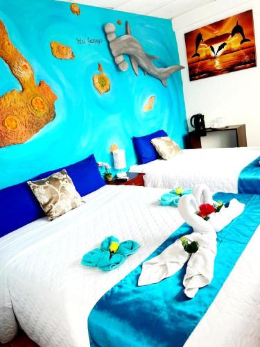 a bedroom with two beds with towels on them at Casa Galarous Island in Puerto Ayora