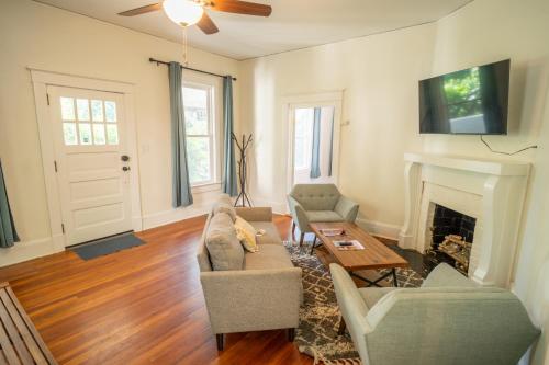 a living room with a couch and a fireplace at Walk to Duke Campus! 3 Bedroom in Trinity Park! in Durham