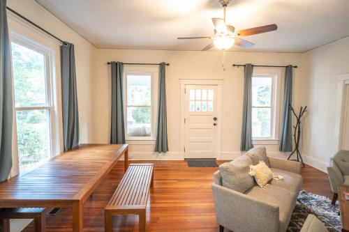 a living room with a table and a couch at Walk to Duke Campus! 3 Bedroom in Trinity Park! in Durham