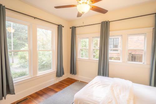 a bedroom with windows and a ceiling fan at Walk to Duke Campus! 3 Bedroom in Trinity Park! in Durham