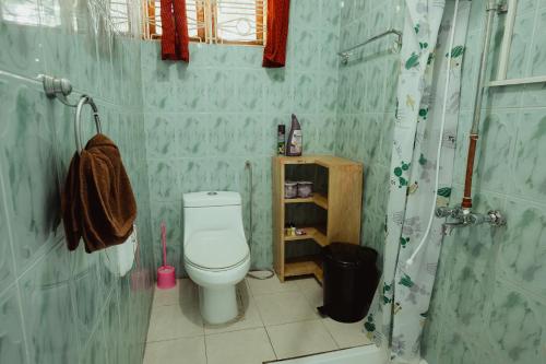 a bathroom with a toilet and a shower at Meru Villa Arusha in Olmotoni