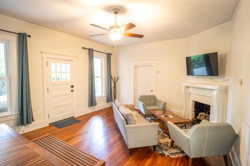 a living room with a couch and a fireplace at Walk to Duke Campus! 3 Bedroom in Trinity Park! in Durham