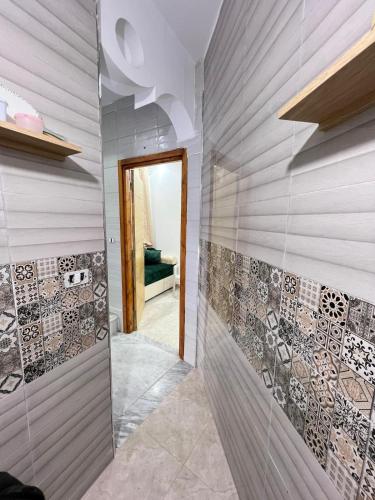 a bathroom with a wall of tile at Great duplex in Monastir in Monastir