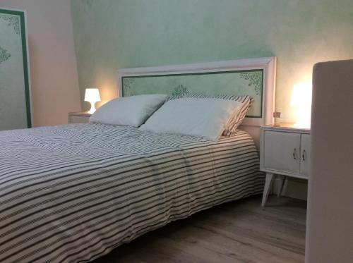 a bedroom with a large bed with two night stands at Le Camere di Casa Cassandra in Perugia
