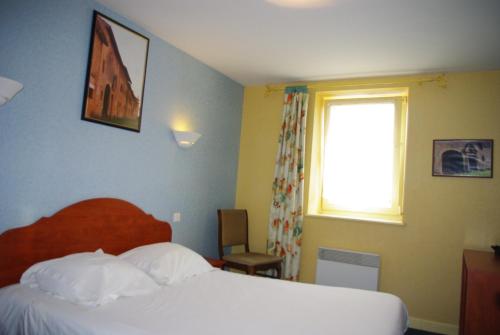 a hotel room with a bed and a window at Auberge de Marville in Marville