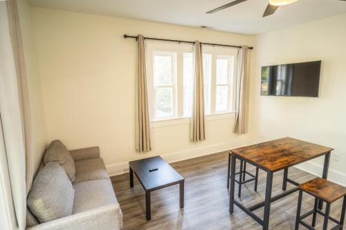 a living room with a couch and a table at Walk to Duke Campus! 1 Bedroom in Trinity Park! in Durham