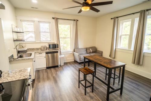 a kitchen with a table and a living room at Walk to Duke Campus! 1 Bedroom in Trinity Park! in Durham