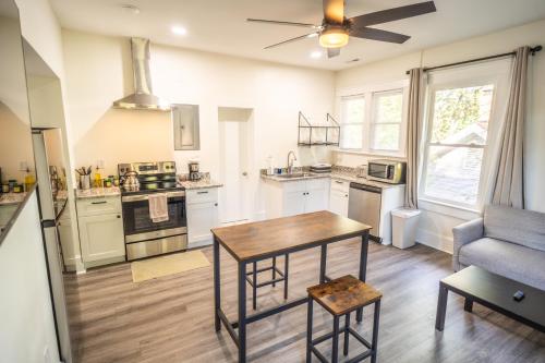 a kitchen with a table and a couch at Walk to Duke Campus! 1 Bedroom in Trinity Park! in Durham