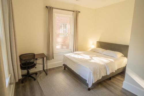 a bedroom with a bed and a desk and a window at Walk to Duke Campus! 1 Bedroom in Trinity Park! in Durham