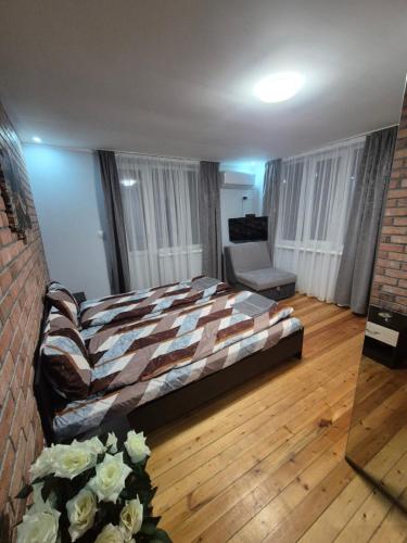a bedroom with a bed and a living room at Къща за гости Белоградчик in Belogradchik