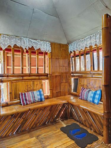 an interior of a boat with wooden seats and windows at INS n OUTZ in Bolinao