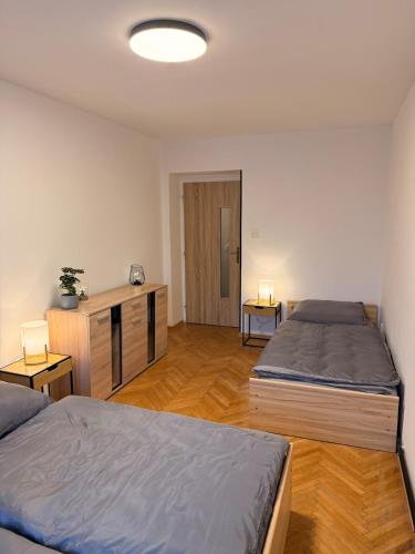 a room with two beds and a desk in it at Duchcov Apartments in Teplice