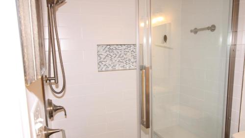 a bathroom with a shower with a glass door at Somewhere In Time Unit 4 in Cape May Point
