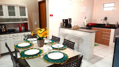 a kitchen with a table with plates on it at Casa de Temporada D'Amaro in Santo Amaro