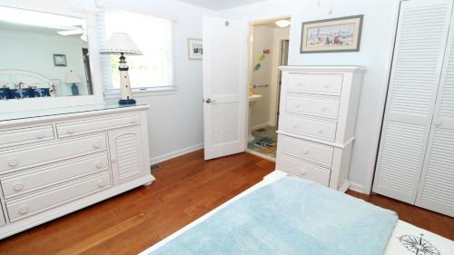 a bathroom with white dressers and a mirror at 324 First Ave in West Cape May